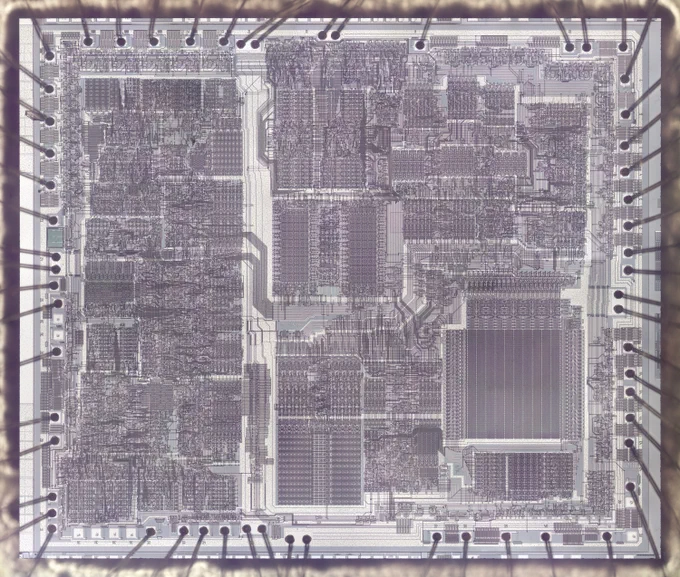 A die photo of the Intel 82586 chip. The metal layer is visible, forming a complex pattern on top of the chip.