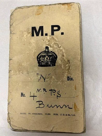 Cover of the pocket book in cream, with a crown and the printed and handwritten inscription 'M.P. "N" Div No. 4 N.R. P.S. Bunn". This shows he held the collar number 4 NR, meaning he was part of that division's reserve, usually made up of the tallest and most-imposing men on a division (he was 5 foot 8 3/4 inches tall) and used for policing protests and major events. Clapham-born, other records in our collection show Bunn (1869-1955) had served in the Royal Marine Artillery (1886-1892) before working as a warehouseman and then in the Met (1895-1920).