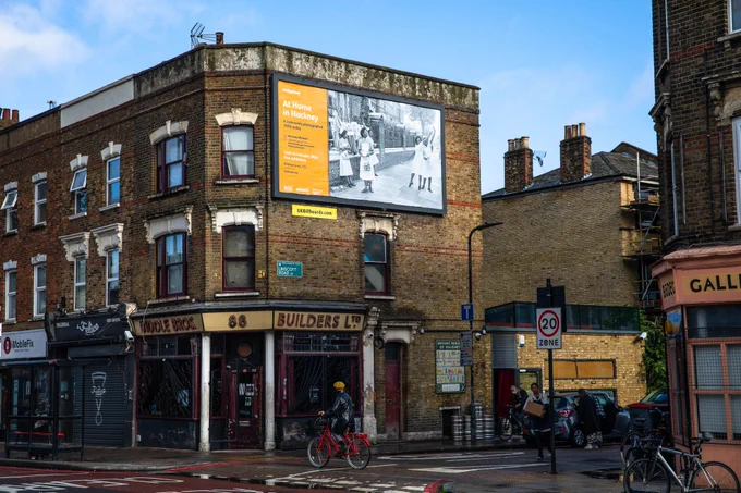 Picture 1 is of billboard above Biddle Bros pub on Lower Clapton Road. Billboard advertises At Home in Hackney exhibition with black and white photo of nurses raising awareness of their strike on the street. 
