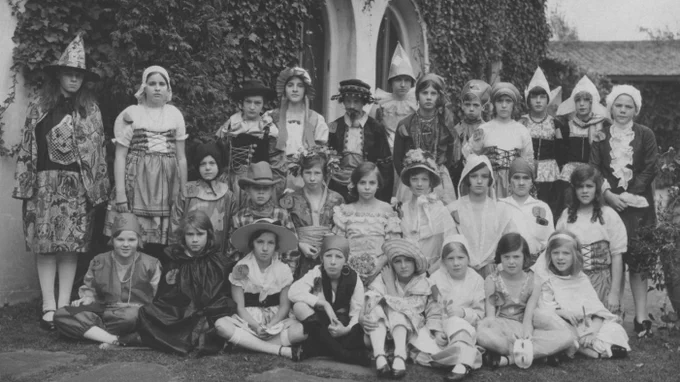 A group of approximately 30 students dressed up for Halloween during the 1920s. 