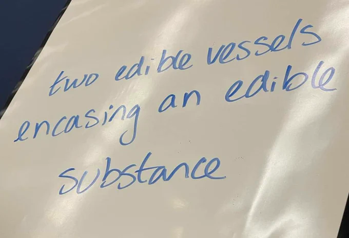 A wipebook with the written message " two edible vessels encasing an edible substance"