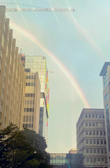 Rainbow arching across V C U M C V Campus buildings.
