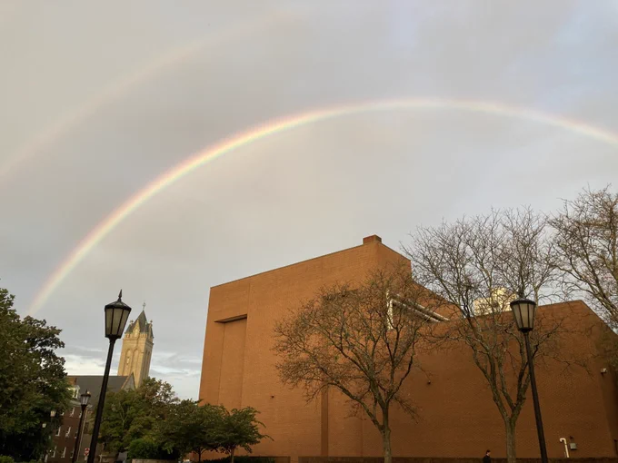 Rainbow arching across V C U Monroe Park Campus buildings.