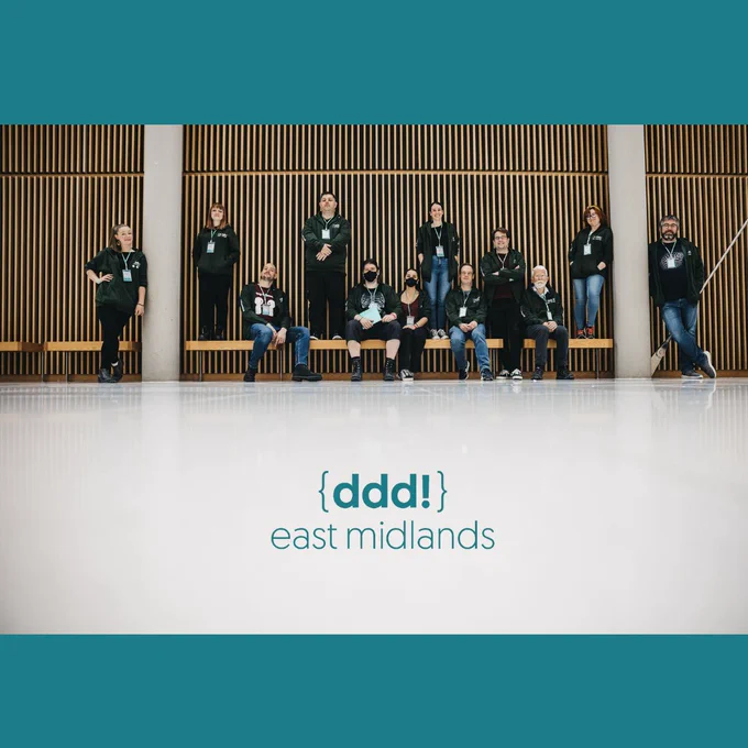 A picture of most of the volunteers in a row wearing their green hoodies