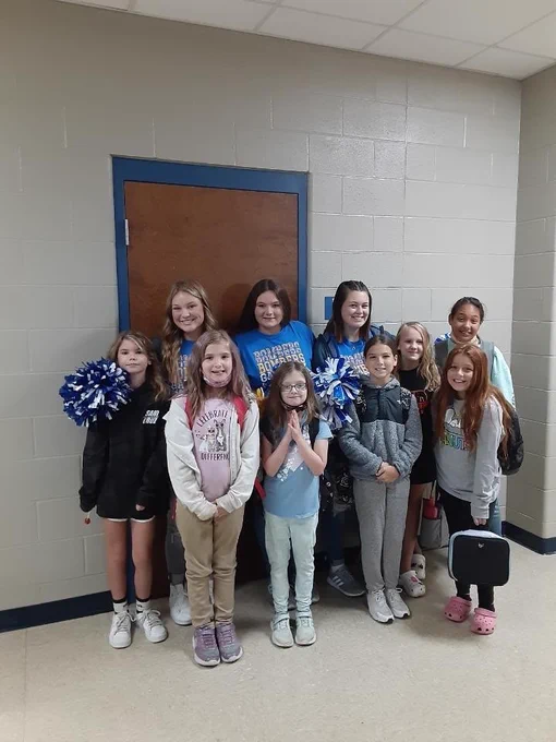 cheerleaders with younger students 