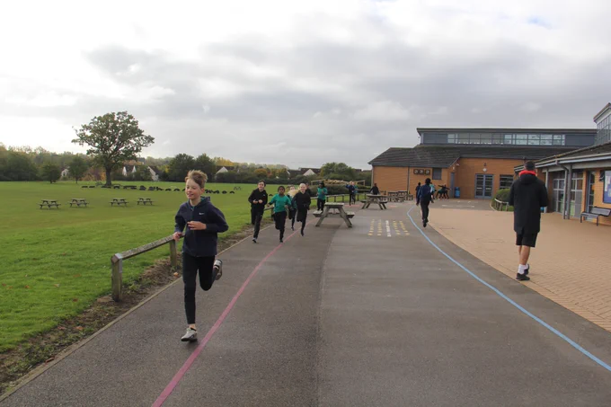 children jog along our daily mile track on a school playground