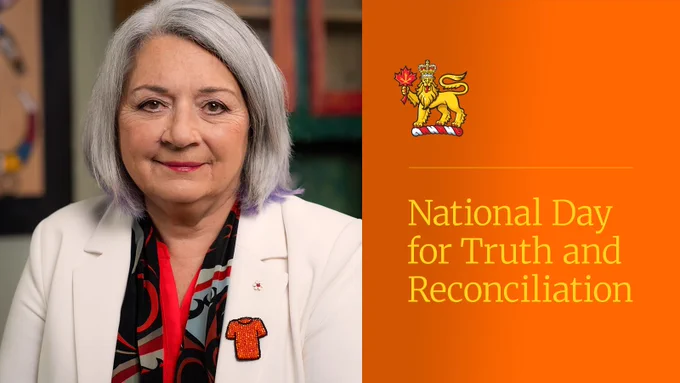 A photo of the Governor General occupies the left side of the image. The Governor General smiles at the camera. She is wearing a black and red blouse with a white blazer. A beaded pin representing an orange t-shirt is pinned to her blazer. The right side of the image is filled with an orange background. There is a viceregal lion in the upper middle of the image. The following text is written in yellow under the viceregal lion: “National Day for Truth and Reconciliation.”