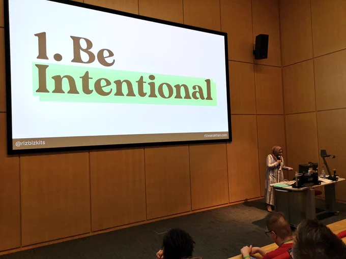 Rizwana presenting at DDD East Midlands. Slide reads 'Be intentional'