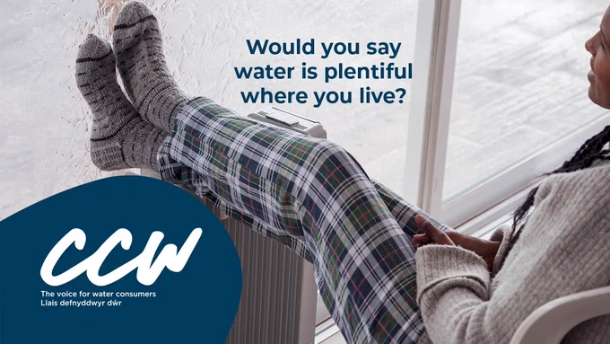A woman in cosy pyjamas and woolly socks sits at the window, with her feet propped on a radiator, and looks out in a cold rainy day. Text: Would you say water is plentiful where you live?
