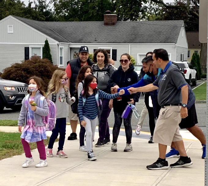 teacher greets students and parents