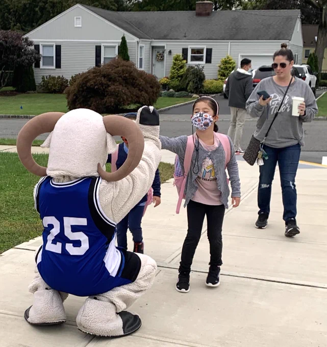 mascot fist bumps student