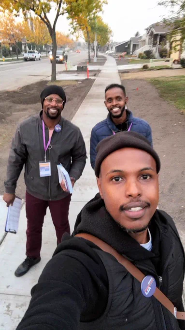 Selfie of Ahmed Knowmadic Ali and volunteers smiling at the camera.