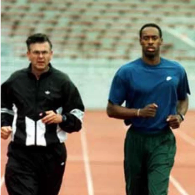 Coach John Zubovich jogs with Olympian Butch Reynolds during a training session.