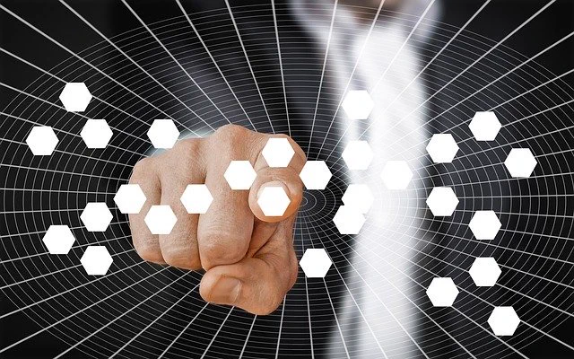 Finger pointing in an abstract of dots representing users or sites. 