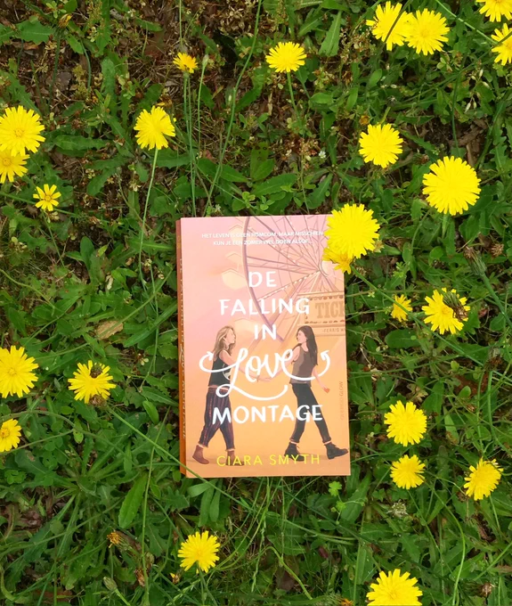 Picture of the book The Falling in Love Montage in a field of flowers.
