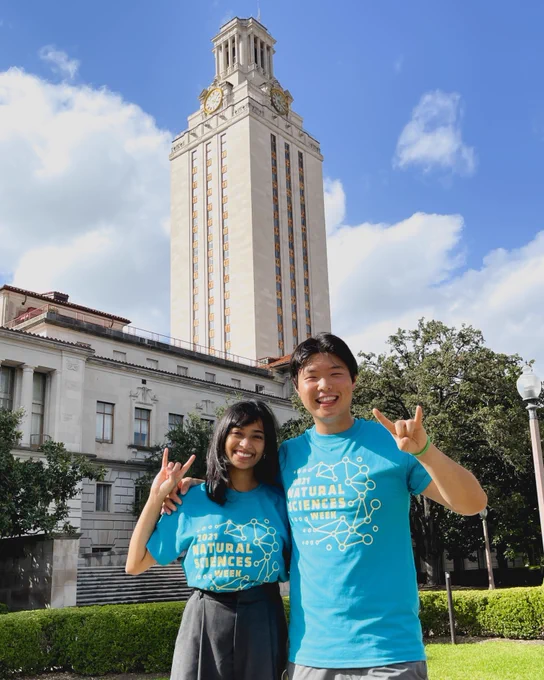 Zuena Karim and Chris Chun giving hook’em signs in front of The University of Texas Tower.