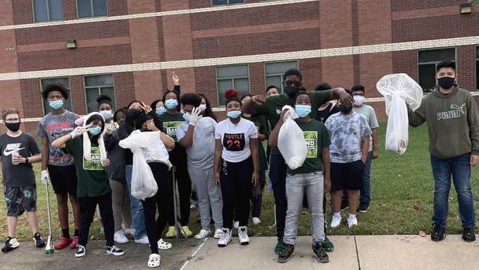 Polk MS students pose for a group photo while picking up trash for the #LeadTheWayChallenge.