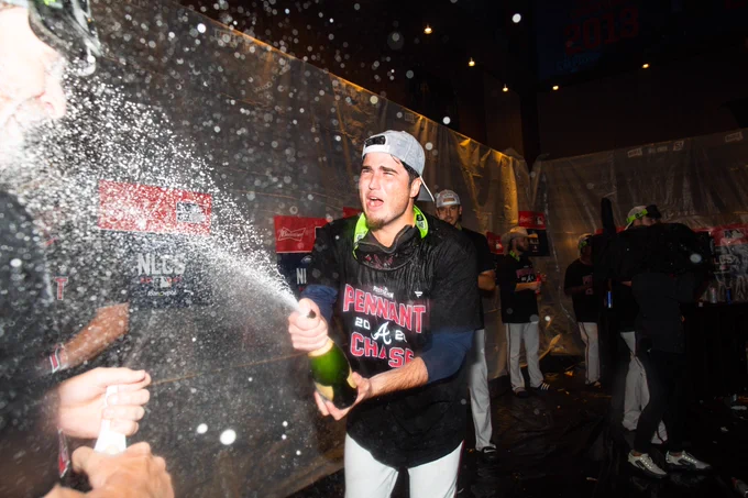 Luke Jackson sprays champagne all over the clubhouse.