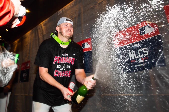 The Braves spray champagne all over the clubhouse.