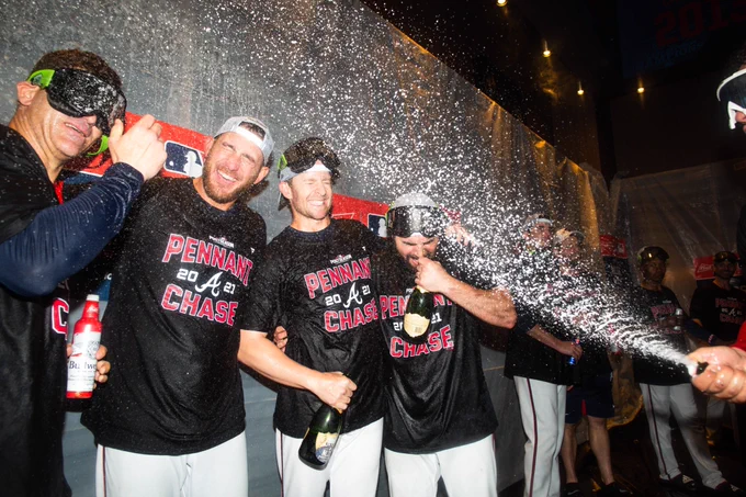 The Braves spray champagne all over the clubhouse.