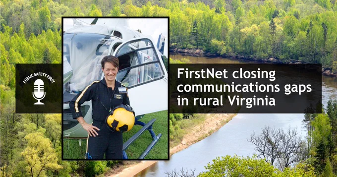 "FirstNet closing communication gaps in rural Virginia;" Tabitha Smithers standing in flight gear holding her helmet outside of a helocopter on a grassy field during the day