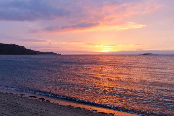 The sun rising above the horizon
