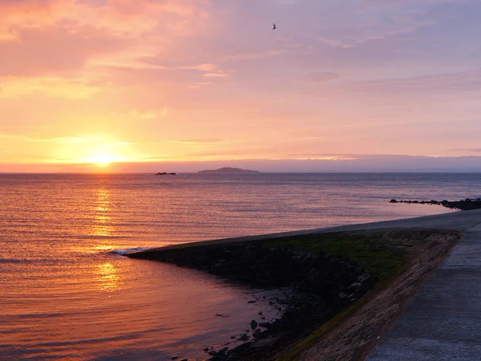 Looking across the sea to the sunrise, at the slipway