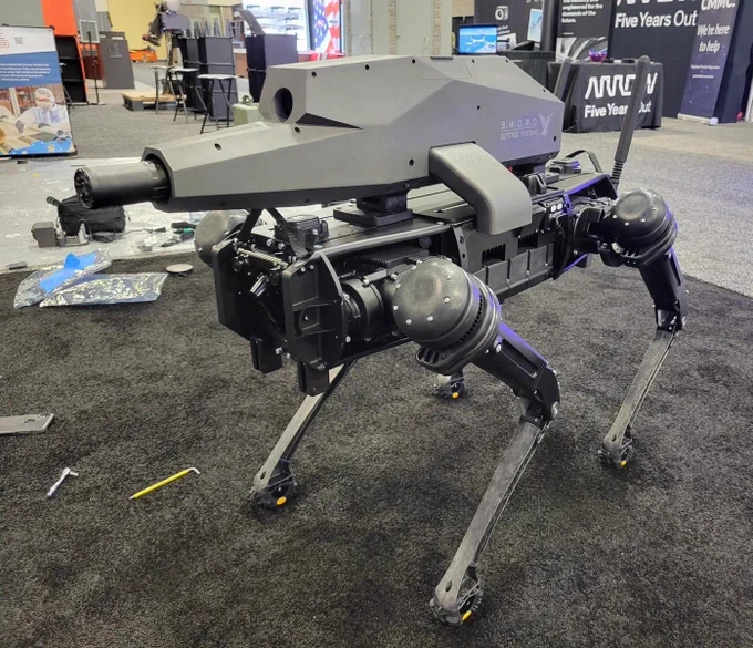 A "SWORD Defense System" four-legged robot with a integrated gun mounted on top.