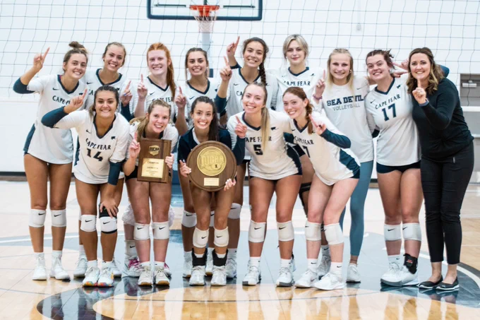 CFCC Volleyball team picture holding region 10 championship plaques