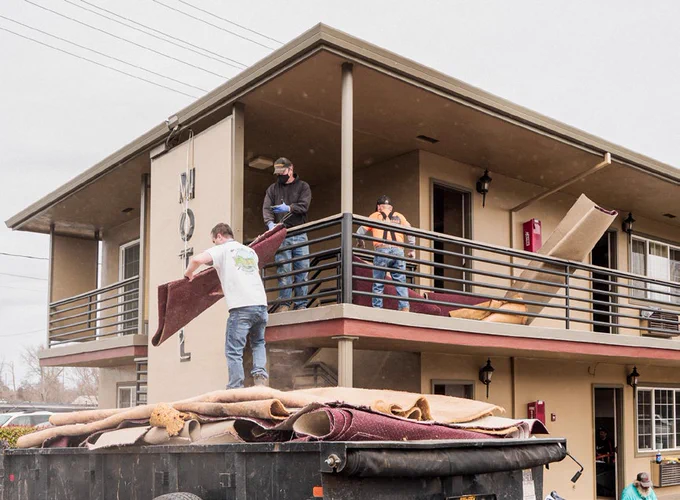 Contractors replacing carpets at a motel in Medford that is housing fire survivors. 