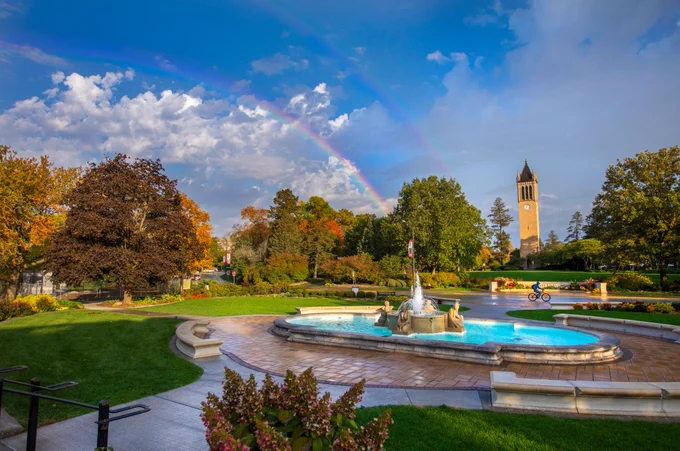 Double rainbow over university campus, with view of fountain and campanile