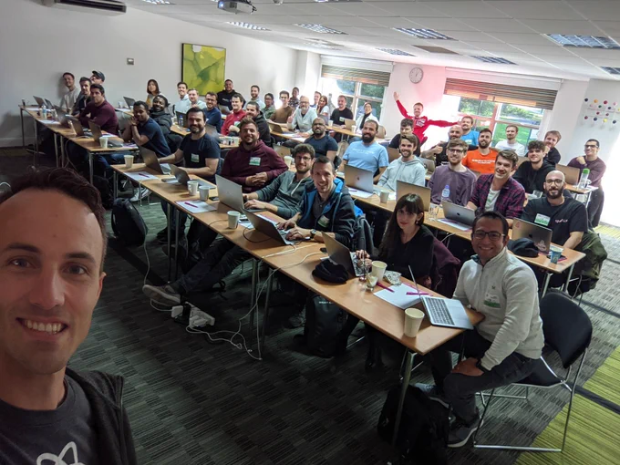Kent taking a selfie with about 40 people in a workshop setting