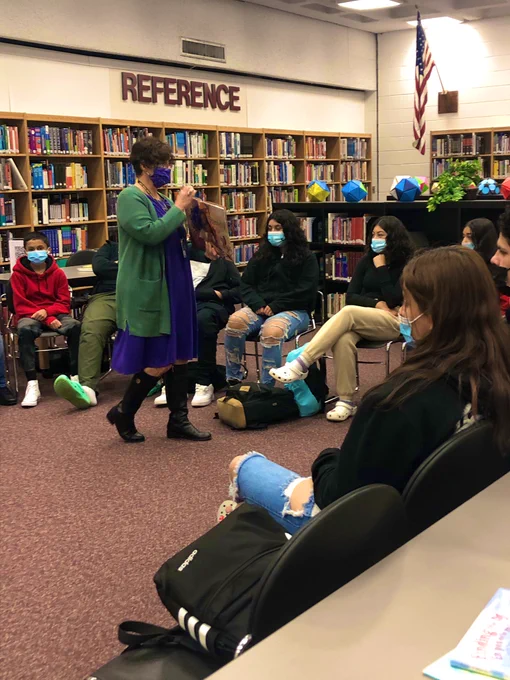 Librarian Mrs. Barbuzza reads a story book to the class