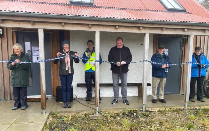 Invited guests untie a ribbon to officially open the Greenmyres facility. Interim chairman of the Gordon and Ena Baxter Foundation, George McIntyre, (second right) was delighted to attend Sunday's community event.