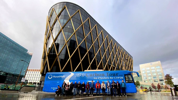 DataJam team stood outside the battle bus in front of The Catalyst building