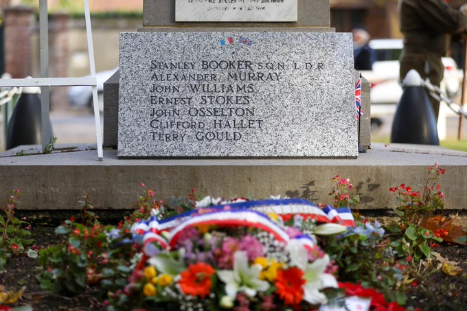 Image shows headstone with crew members names.