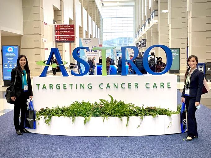 Lisa and Christina posing next to ASTRO sign