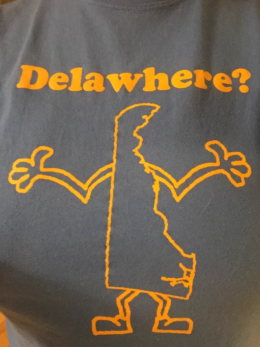 Cartoon image of the State of Delaware with arms and feet added. Arms are outstretched in a way that looks like someone shrugging their shoulders in response to a question. The question “Delawhere?”appears above the image.