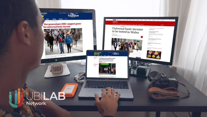 A photo of a man sitting at a desk with a laptop and two desktop screens. On the screens are various news stories about UBI Lab Network projects in The Guardian and the BBC News. In the corner of the image is the UBI Lab Network logo.