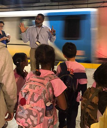 BART Transportation Operations Managers Eric Matthews talks to children on a summer youth tour in 2019 