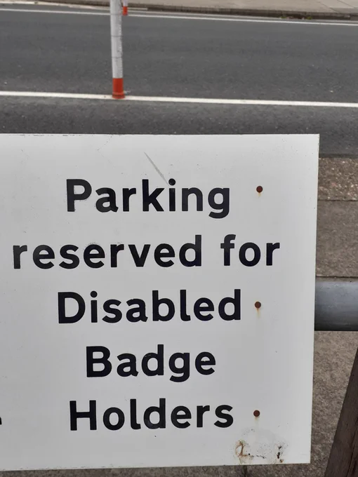 A parking sign which reads "Parking reserved for Disabled Badge Holders"