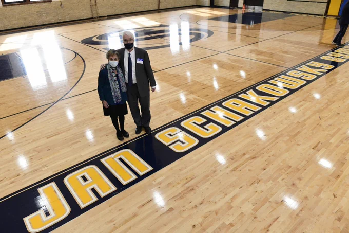 President Killeen and Jan Schakowsky take a photo in a gymnasium. 
