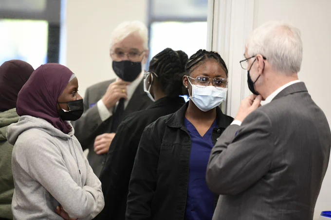 President Killeen speaks with two women. 