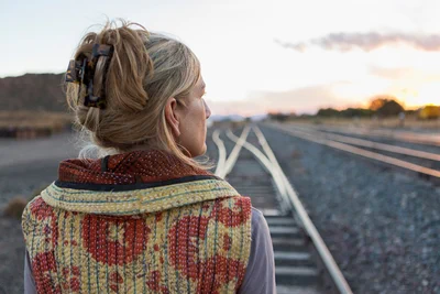 woman gazing at train tracks