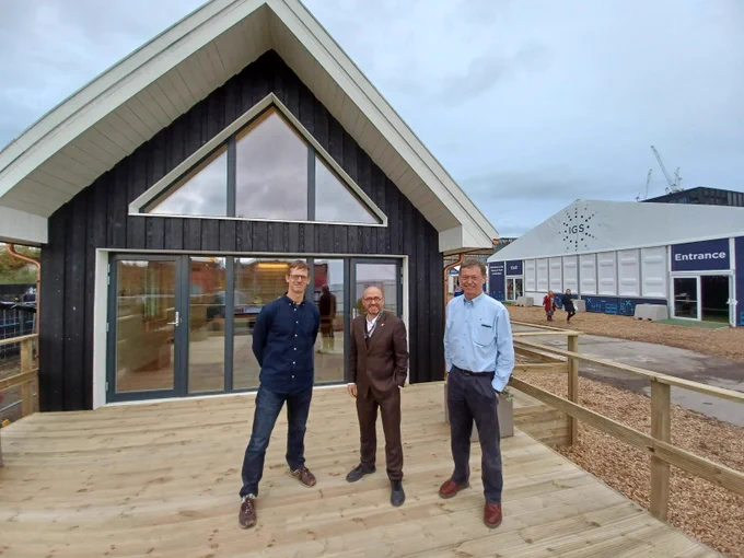 Photo of Peter Smith (architect), Patrick Harvie and Hamish Macleod of BSW Timber outside the COP26 zero carbon house.