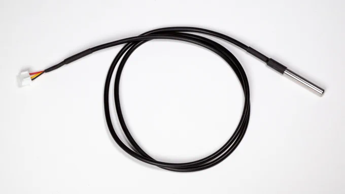 Photo of MCCI temperature probe, JST-XH connector on left, stainless-steel probe on right, coiled cable in middle.