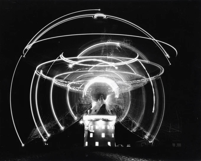 A black and white timelapse image of the Parkes radio telescope.