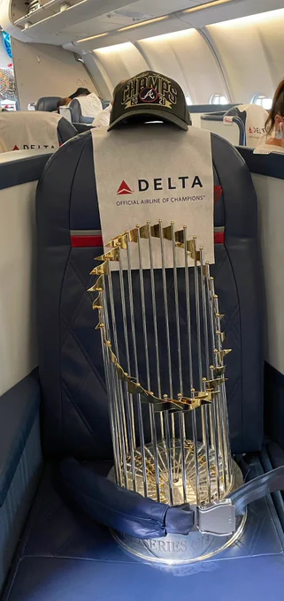 Picture of the World Series trophy on a seat on the team plane