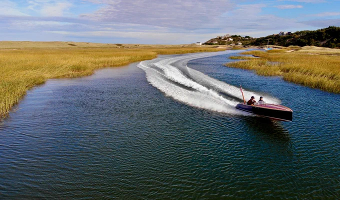 Photo of Reward 17 cruising through a salt marsh with 2 occupants on a windy fall day