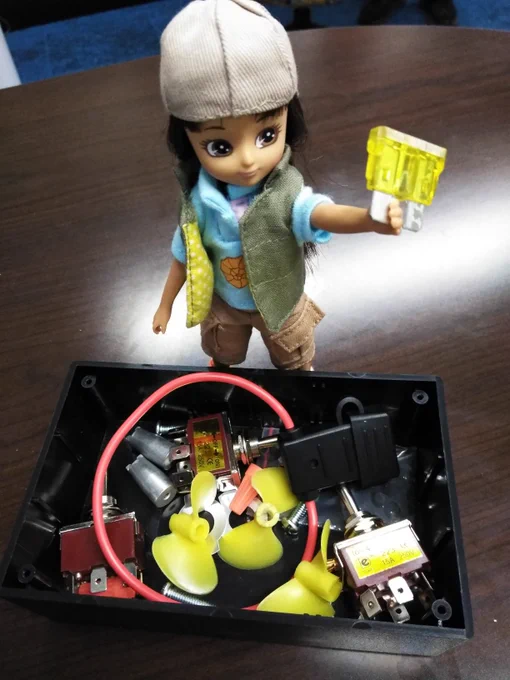 Lottie doll helps @ROV_Erica build underwater robots by handing her fuse and switches so students can build a robot.